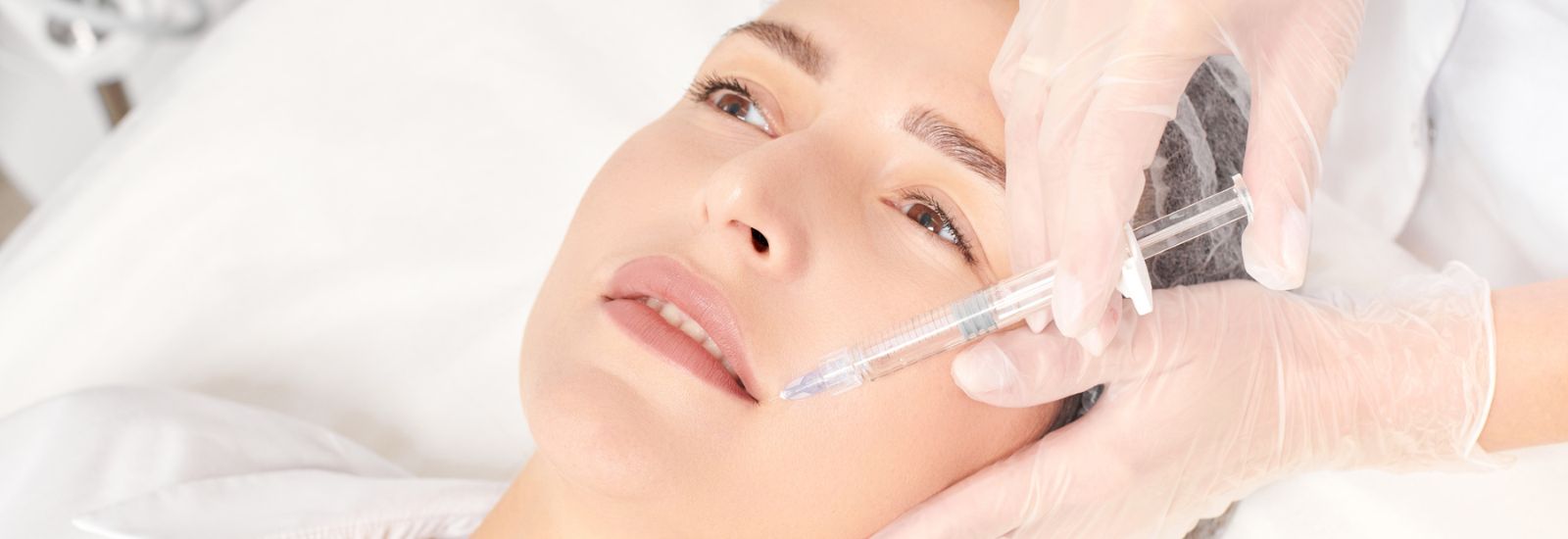 Cosmetologist makes fillers injection for lips augmentation - Restylane
